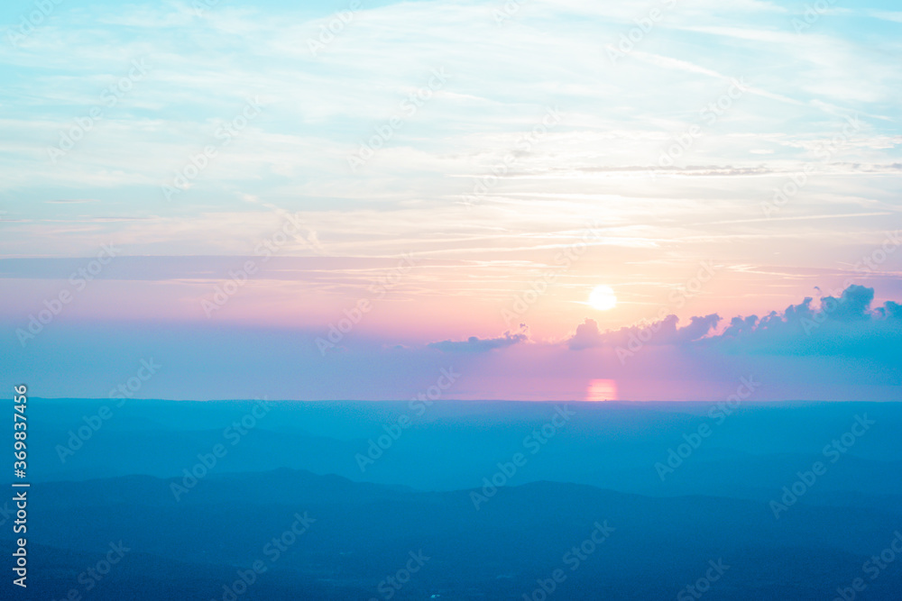 pastel colored sunset with mountains