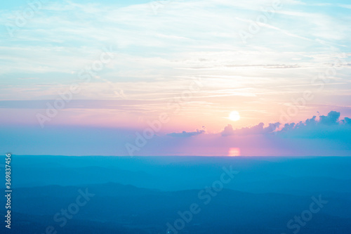pastel colored sunset with mountains