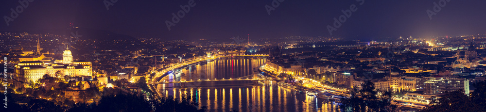 View of the illuminated Buda Castle and the Chain Bridge at night in Budapest