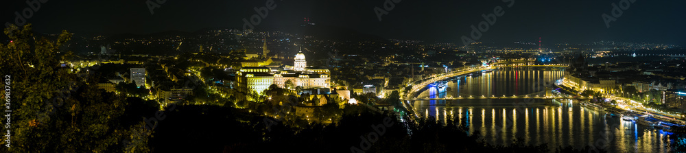 View of the illuminated Buda Castle and the Chain Bridge at night in Budapest