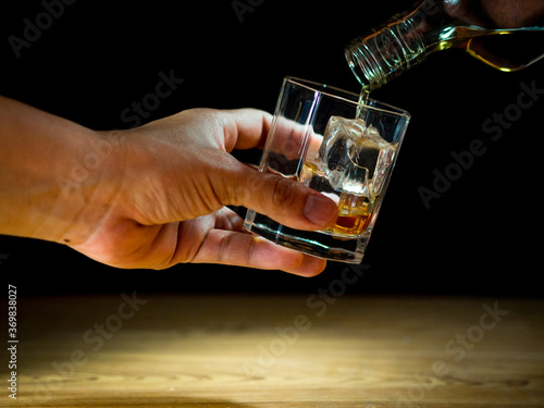 Low light photography of whiskey drinking concept