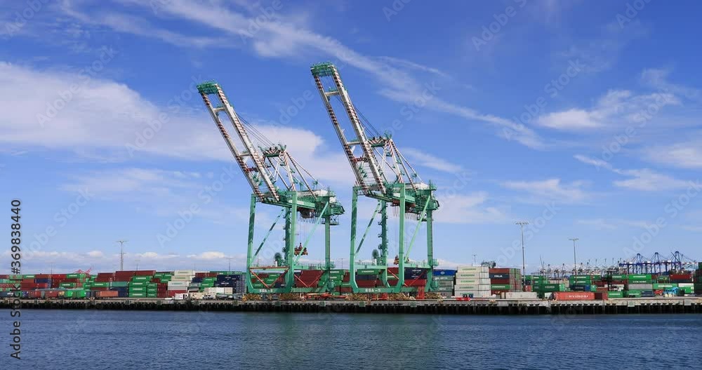 Long Beach California industrial cargo cranes 4K. Port of Los Angeles, America's Port. Two billion dollars of products transfer from container ship to and from worldwide destinations. Long Beach California industrial cargo cranes 4K. Port of Los Angeles, America's Port. Two billion dollars of products transfer from container ship to and from worldwide destinations.