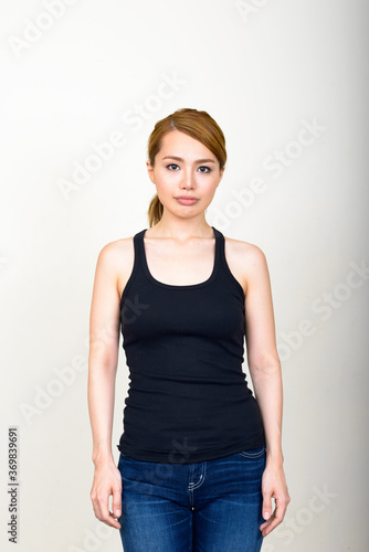 Portrait of young beautiful Asian woman against white background © Ranta Images