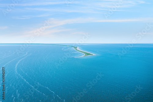 Beautiful seascape with spit under blue sky