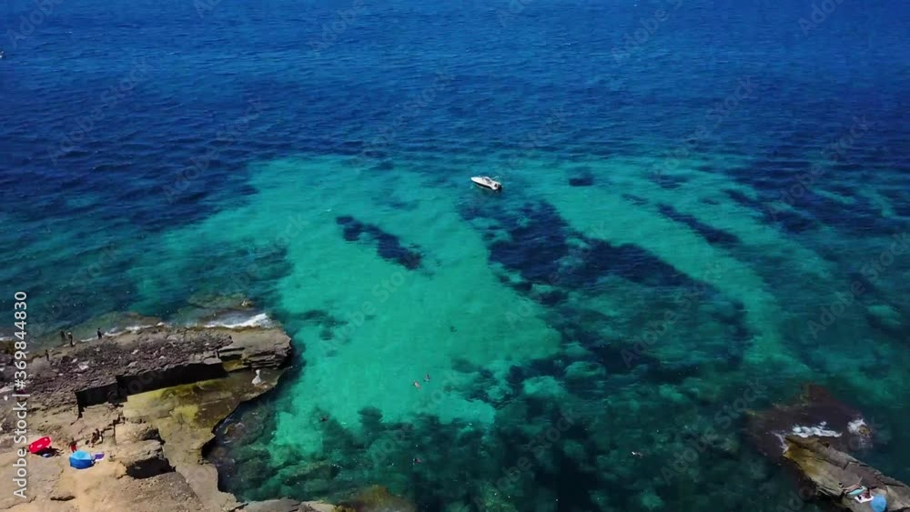 Ocean reveal. Slow reveal from a rocky shore to the sea and boats. Ocean reveal. Slow reveal from a rocky shore to the sea and boats.