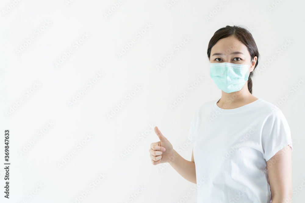 Asian young attractive woman wearing a protective hygiene mask over her face to protect flu and virus. Asian young attractive woman wearing a protective hygiene mask over her face to protect flu and virus.