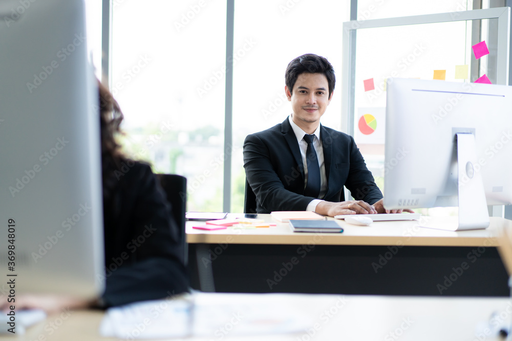 Small group of businesspeople working in their office with social distancing protocol during the Coronavirus or COVID-19 disease. Working people avoid stay closer to each other to protect from COVID19 Small group of businesspeople working in their office with social distancing protocol during the Coronavirus or COVID-19 disease. Working people avoid stay closer to each other to protect from COVID19