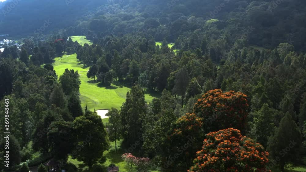 Aerial view of the green fairways of a gold course in the Bedugul resort area of Bali. Drone aerial forward motion Aerial view of the green fairways of a gold course in the Bedugul resort area of Bali. Drone aerial forward motion