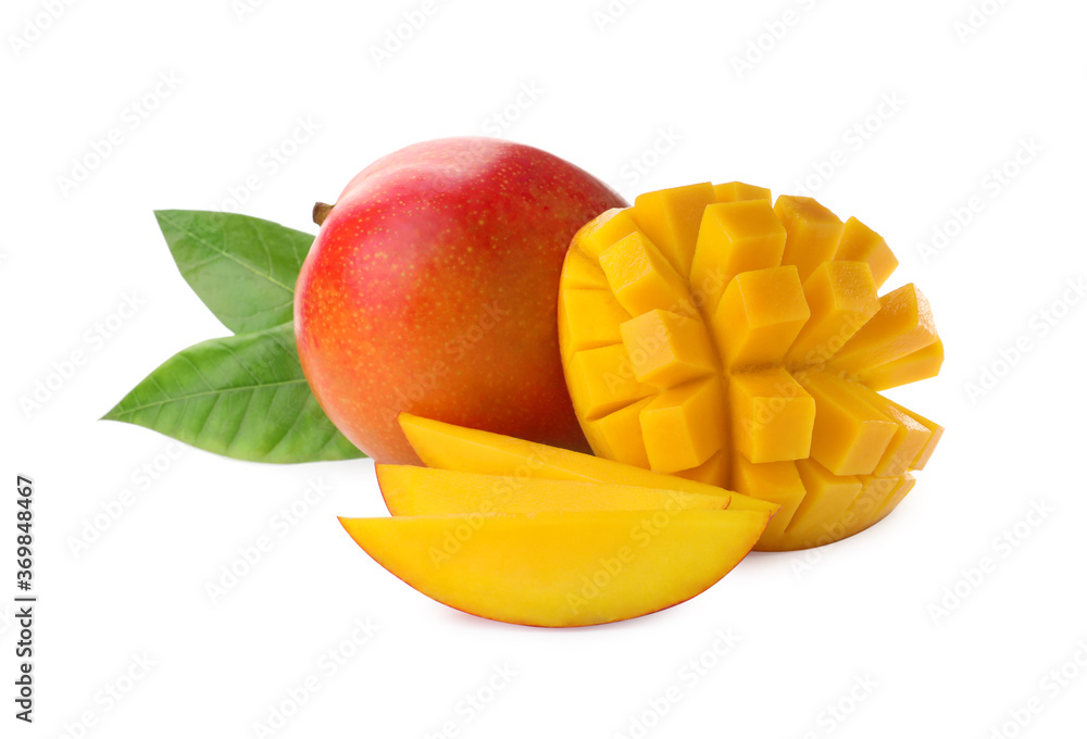 Whole and cut ripe mangoes isolated on white. Exotic fruit Whole and cut ripe mangoes isolated on white. Exotic fruit