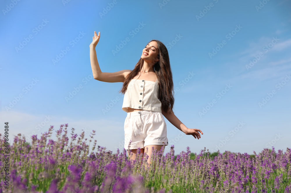 Young woman in lavender field on summer day Young woman in lavender field on summer day