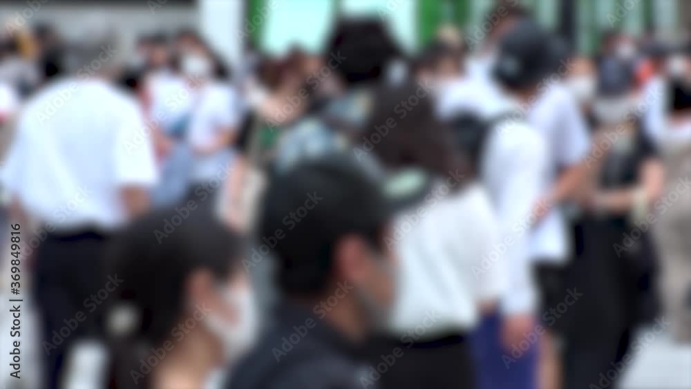 SHIBUYA, TOKYO, JAPAN - AUG 2020 : Crowd of people wearing surgical mask to protect from Coronavirus (COVID-19) at Shibuya Crossing. Shot in day time, hot summer season. Blurred slow motion. SHIBUYA, TOKYO, JAPAN - AUG 2020 : Crowd of people wearing surgical mask to protect from Coronavirus (COVID-19) at Shibuya Crossing. Shot in day time, hot summer season. Blurred slow motion.