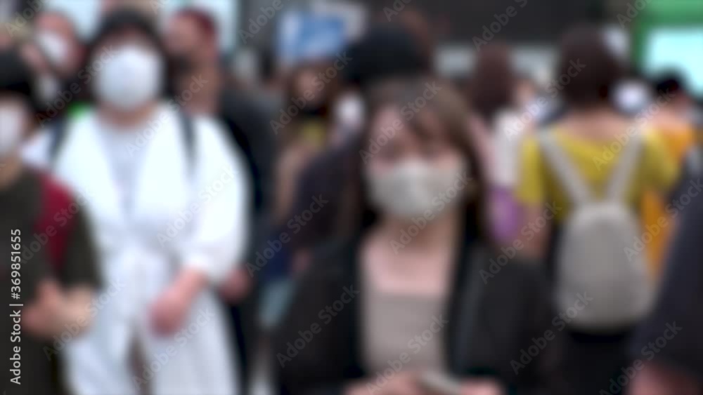 SHIBUYA, TOKYO, JAPAN - AUG 2020 : Crowd of people wearing surgical mask to protect from Coronavirus (COVID-19) at Shibuya Crossing. Shot in day time, hot summer season. Blurred slow motion. SHIBUYA, TOKYO, JAPAN - AUG 2020 : Crowd of people wearing surgical mask to protect from Coronavirus (COVID-19) at Shibuya Crossing. Shot in day time, hot summer season. Blurred slow motion.