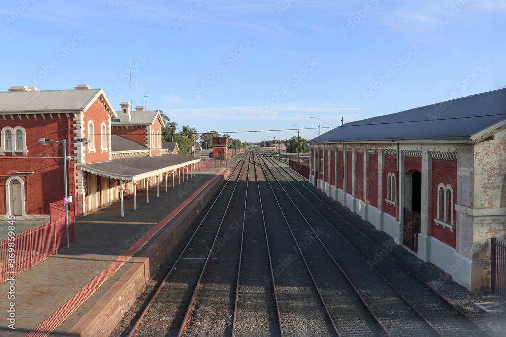 ECHUCA, AUSTRALIA - February 29, 2020: A view of the Echuca railway station platform, water tank and goods shed from the pedestrian footbridge overpass ECHUCA, AUSTRALIA - February 29, 2020: A view of the Echuca railway station platform, water tank and goods shed from the pedestrian footbridge overpass