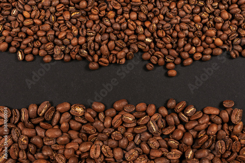Roasted coffee beans. Two sorts of arabica on black background © Oleksandr