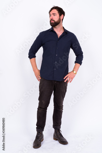 Portrait of handsome bearded businessman against white background