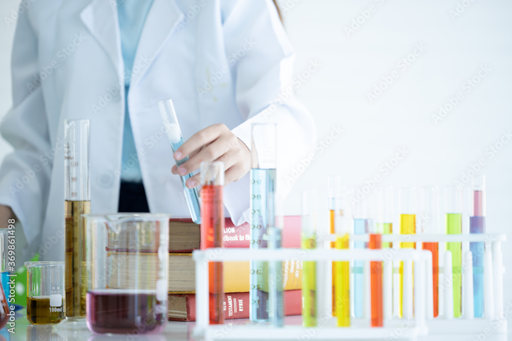 Kid in lab coat learning chemistry in school laboratory, Kid scientist studying science, experimenting with chemicals, Young scientist making experiments laboratory, Child and science, Education. Kid in lab coat learning chemistry in school laboratory, Kid scientist studying science, experimenting with chemicals, Young scientist making experiments laboratory, Child and science, Education.