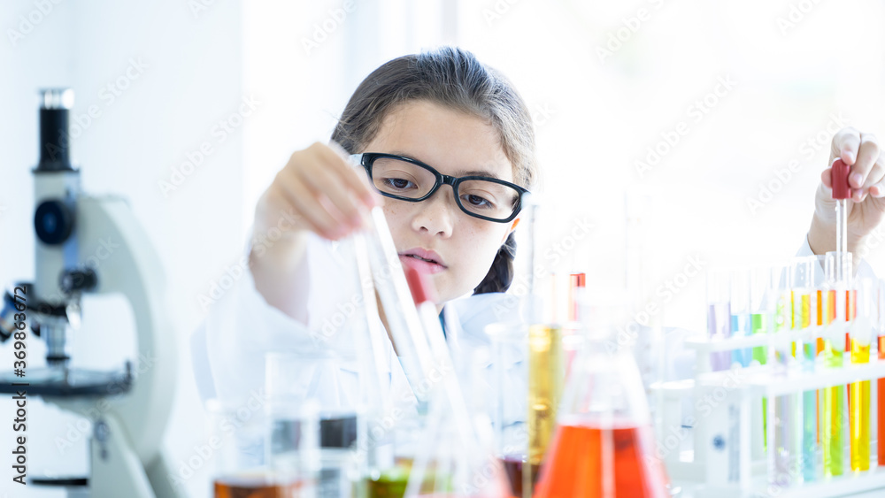 Kid in lab coat learning chemistry in school laboratory, Kid scientist studying science, experimenting with chemicals, Young scientist making experiments laboratory, Child and science, Education. Kid in lab coat learning chemistry in school laboratory, Kid scientist studying science, experimenting with chemicals, Young scientist making experiments laboratory, Child and science, Education.