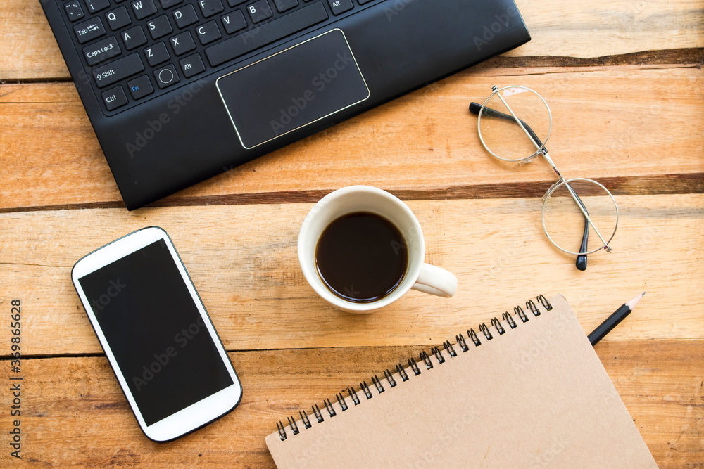 notebook planer ,mobile phone ,computer for business work with hot coffee arrangement flat lay style at office on background wooden notebook planer ,mobile phone ,computer for business work with hot coffee arrangement flat lay style at office on background wooden