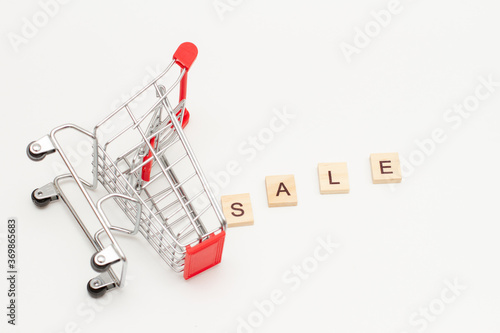 Overturn toys shopping basket and word SALE made from wooden blocks