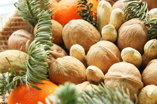 Gift Christmas bouquet. Pine cones, oranges, peanuts, walnuts, spruce branch in a beautiful package. Electoral focus. Christmas and New Year is theme. Holiday theme. Background. Food. View from top