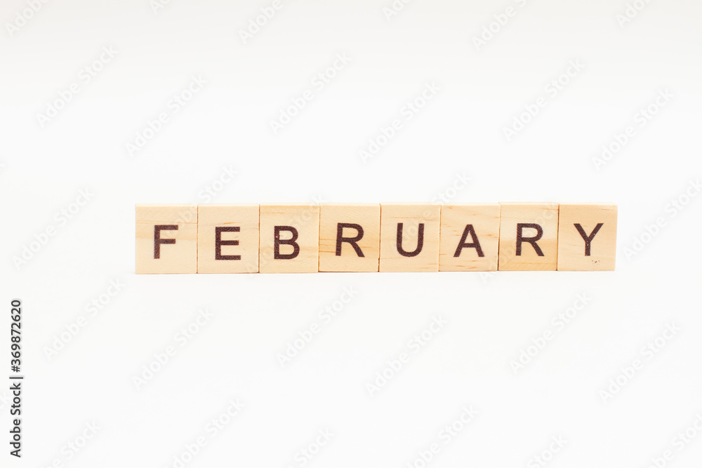 Word February made of wooden blocks on white background. Month of year Word February made of wooden blocks on white background. Month of year