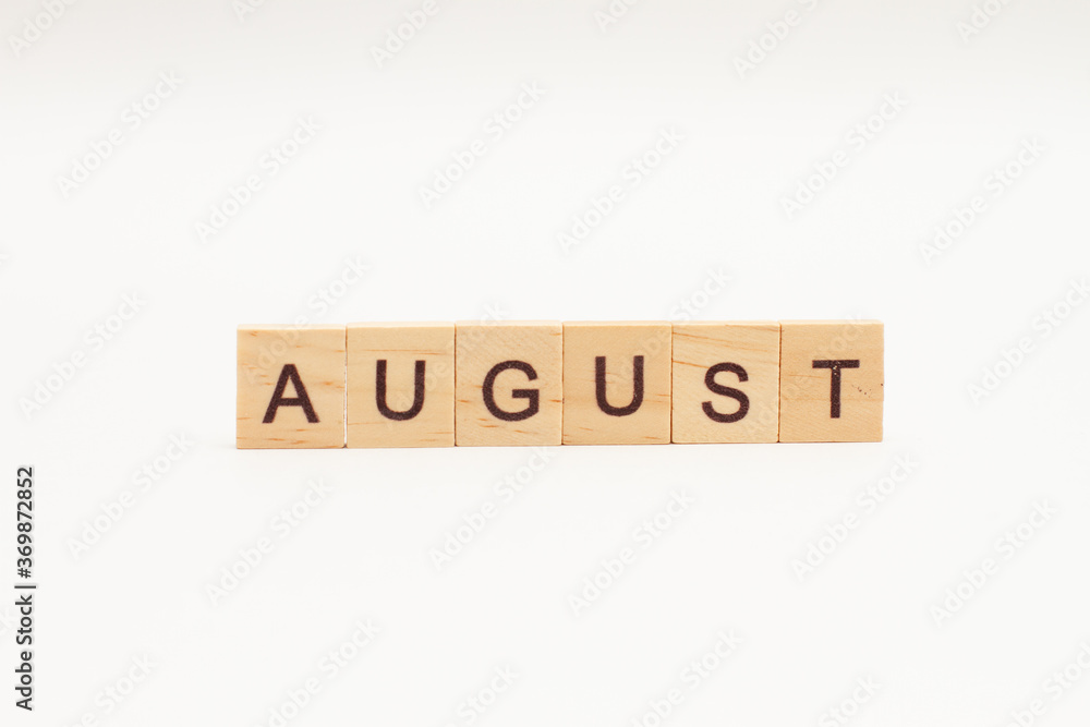 Word AUGUST made of wooden blocks on white background. Month of year. The end of the summer Word AUGUST made of wooden blocks on white background. Month of year. The end of the summer