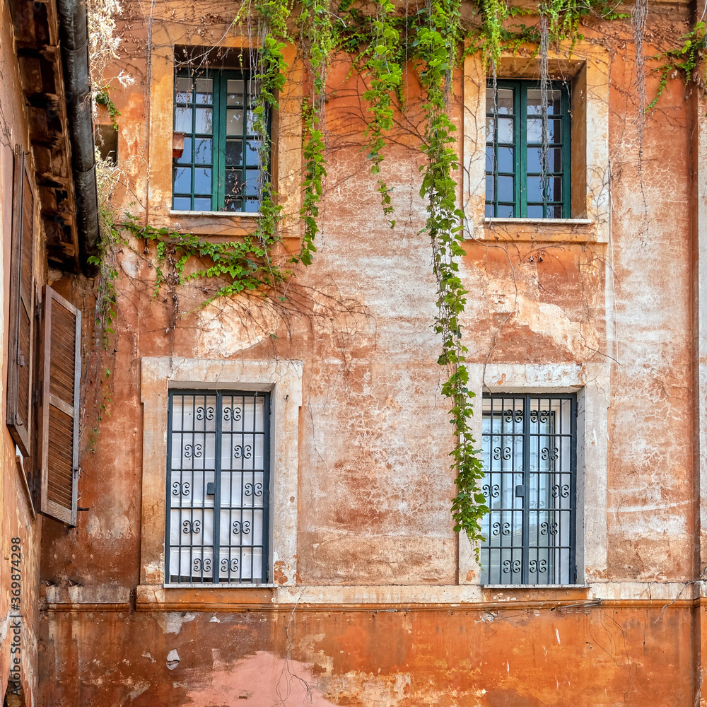 four vintage windows on colorful wall, Rome Italy