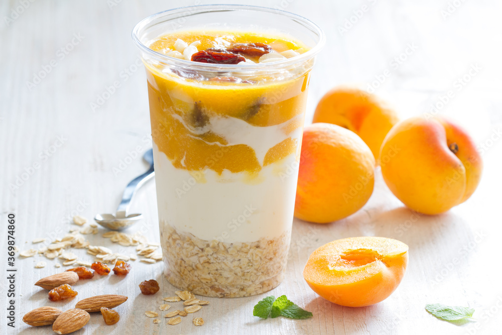 Yogurt with oatmeal, apricots, raisins and almonds. Healthy and nutritious snack Yogurt with oatmeal, apricots, raisins and almonds. Healthy and nutritious snack