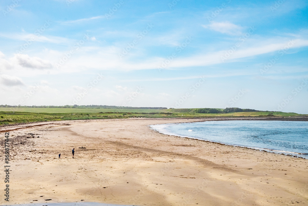 A beach at the north coast of Scotland, on a sunny day.