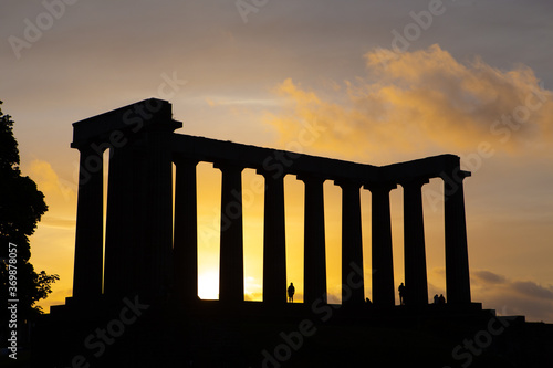 The backlit view of Scotland National Monument in Edinburgh, at sunset.