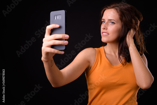 Portrait of young beautiful woman taking selfie