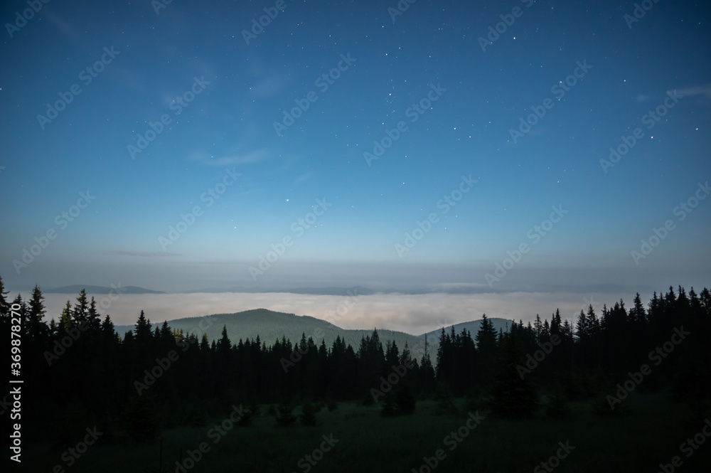 The night sky in the Carpathian mountains before sunrise