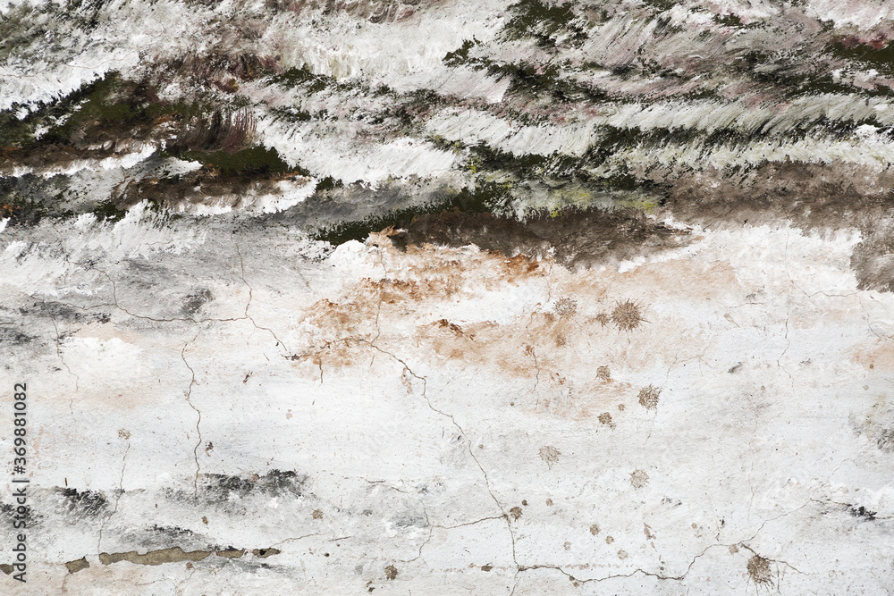 Fototapeta premium Abstract creative background of chaotic strokes of old cracked paint on concrete wall. Old surface with traces of paint, weathered, scratches and cracks for design