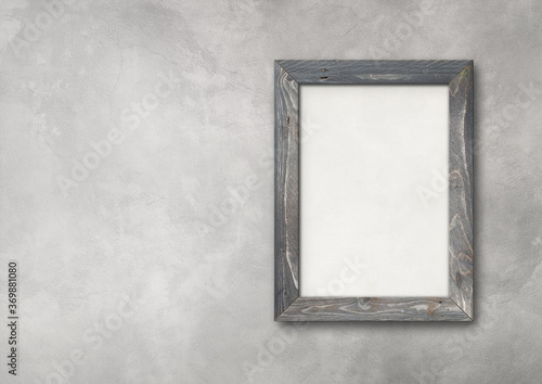 Vintage wooden picture frame mockup on a concrete wall background