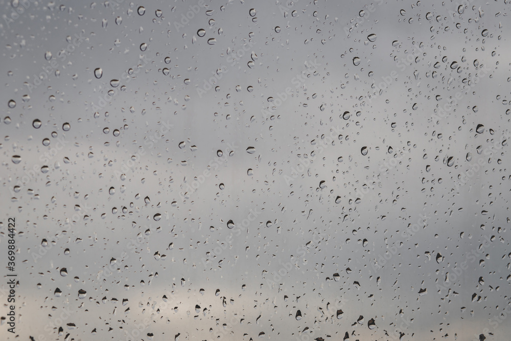 water rain drops on glass surface window with cloudy background. Copy space. Natural Pattern. water rain drops on glass surface window with cloudy background. Copy space. Natural Pattern.