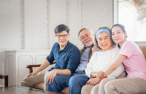 Asian family sitting in living room, Senior father mother and middle aged son and daughter, Happiness family concepts