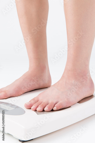 体重計に乗る女性の足元