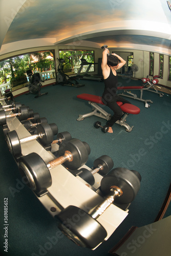 The sport and healthy lifestyle concept, male exercise by dumbbell weights in the gym..