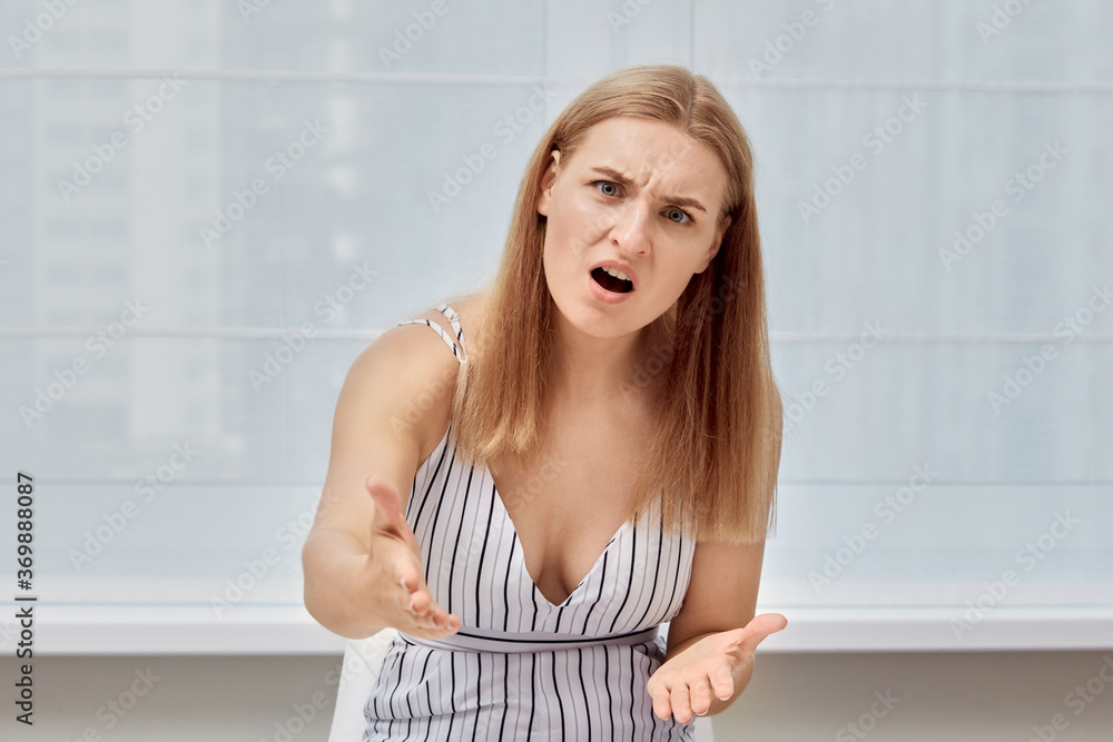 Angry girl looks at the camera and shouts. Negative emotions. Beautiful girl. Angry girl looks at the camera and shouts. Negative emotions. Beautiful girl.