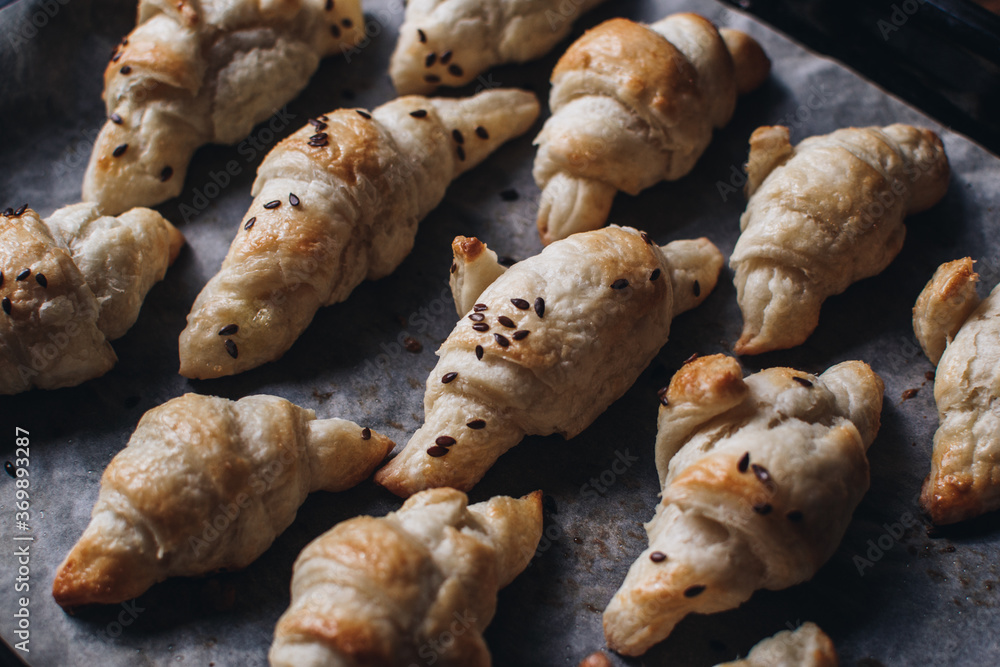 Freshly baked homemade croissants on wooden table, selective focus Fresh out of the oven. Breakfast or brunch concept. Freshly baked homemade croissants on wooden table, selective focus Fresh out of the oven. Breakfast or brunch concept.