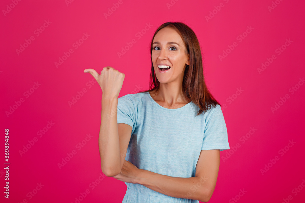 Close-up photo of an impressed lady showing hand gestures, wearing a blue t-shirt isolated on a pink background Close-up photo of an impressed lady showing hand gestures, wearing a blue t-shirt isolated on a pink background