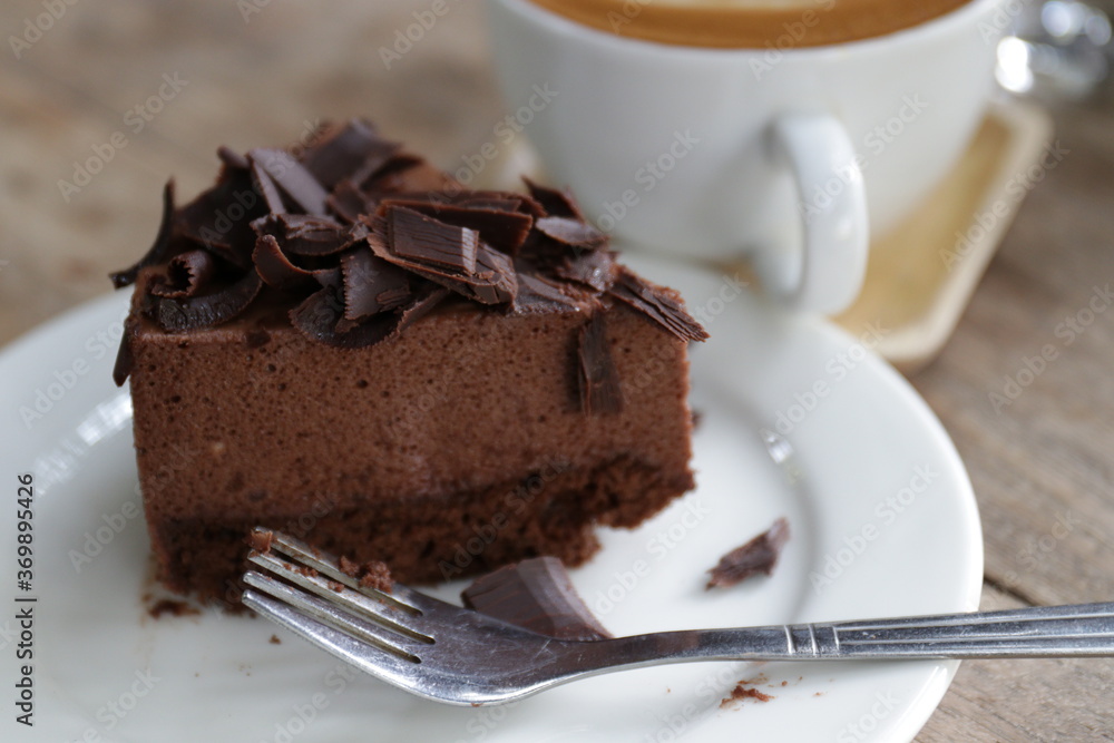 Close up Chocolate Cake , Topped with Shredded Chocolate , a Cup of Hot Latte Close up Chocolate Cake , Topped with Shredded Chocolate , a Cup of Hot Latte