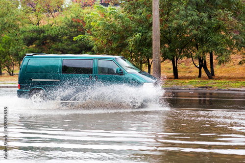 Driving cars on a flooded road during flooding caused by torrential rains. Cars float on water flooded streets. The disaster in Odessa