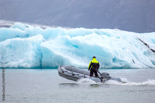 man on a fast motor boat sailing on a glacier lagoon in Iceland
