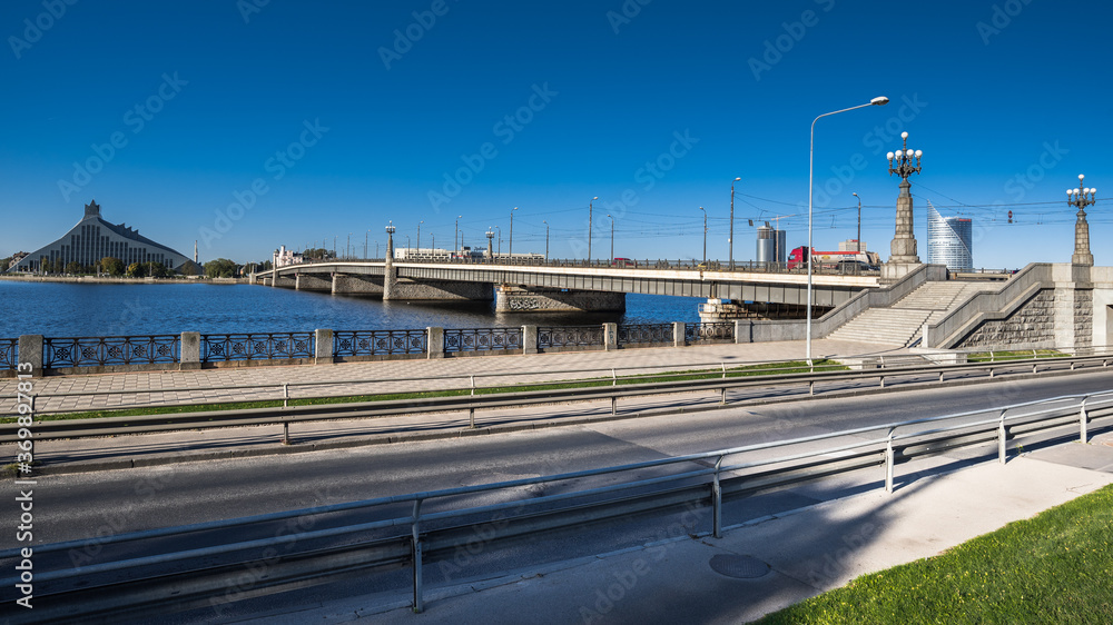 The Stone Bridge (Akmens tilts) and the Railway Bridge (Dxelzcela tilts) across Daugava river, Riga, Latvia. The Stone Bridge (Akmens tilts) and the Railway Bridge (Dxelzcela tilts) across Daugava river, Riga, Latvia.