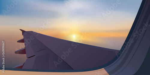Concept du voyage et du transport aérien avec une aile d’avion vue au traver d’un hublot, sur un fond de coucher de soleil.