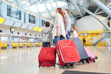 Family and children with many suitcases in the airport