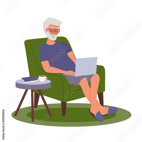 Young man with laptop is works in home chair