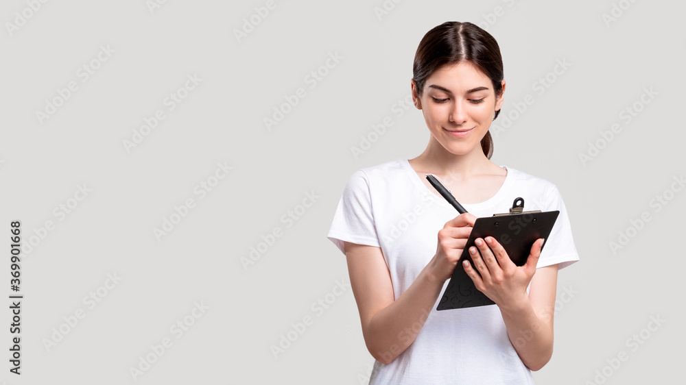 Social survey. Project research. Cheerful female assistant working on strategy planning with clipboard isolated on white copy space. Business startup. Social survey. Project research. Cheerful female assistant working on strategy planning with clipboard isolated on white copy space. Business startup.