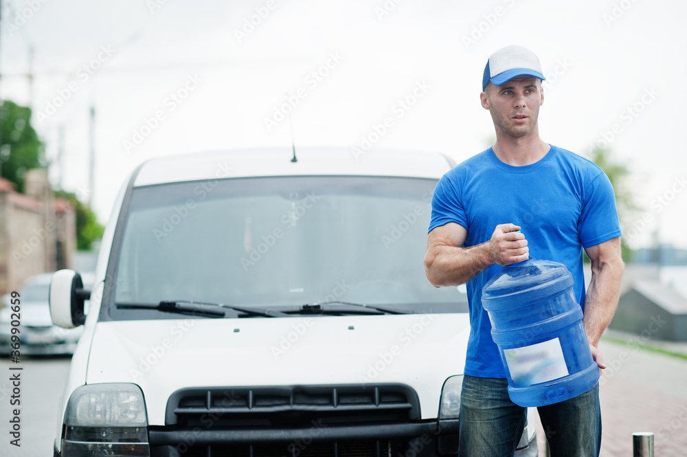 Delivery man in front cargo van delivering bottles of water. Delivery man in front cargo van delivering bottles of water.
